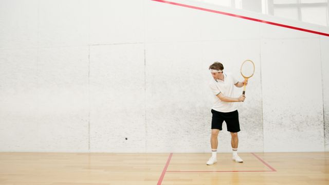 Squash player on an indoor court